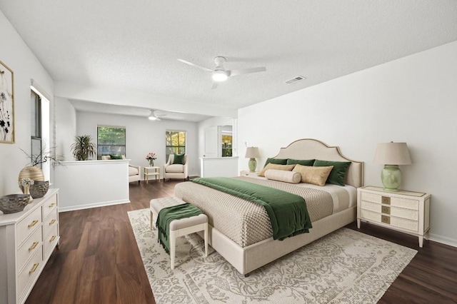 12025 Wycliff Ln, Austin, TX 78727 - bedroom featuring a textured ceiling, dark wood-style floors, and ceiling fan