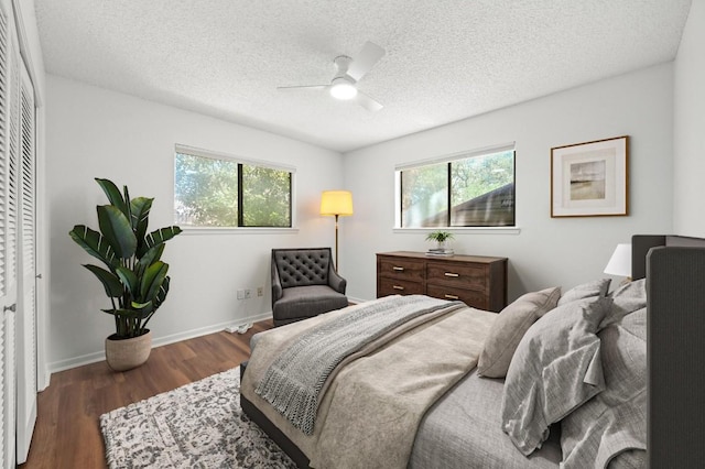 12025 Wycliff Ln, Austin, TX 78727 - bedroom featuring multiple windows, wood finished floors, a textured ceiling, a closet, and a ceiling fan