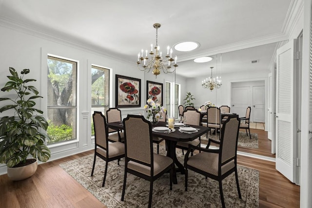 dining space with a chandelier, ornamental molding, and dark wood finished floors