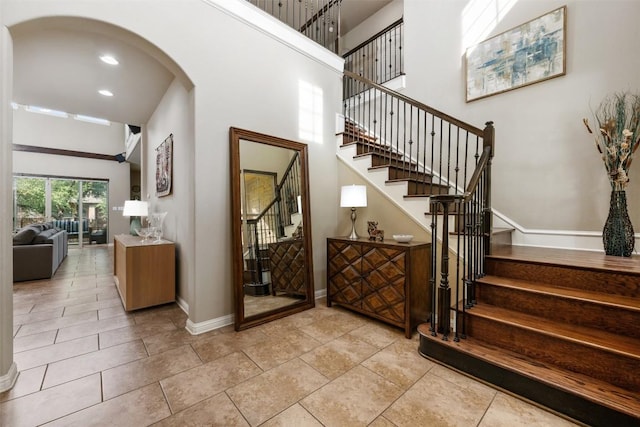 402 Dry Gulch Bnd, Cedar Park, TX 78613 - stairway with baseboards, arched walkways, and a towering ceiling