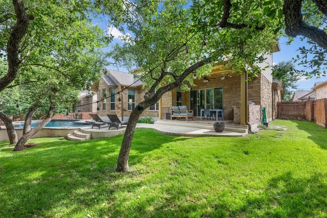 402 Dry Gulch Bnd, Cedar Park, TX 78613 - rear view of house with stone siding, a ceiling fan, a patio area, and a fenced backyard