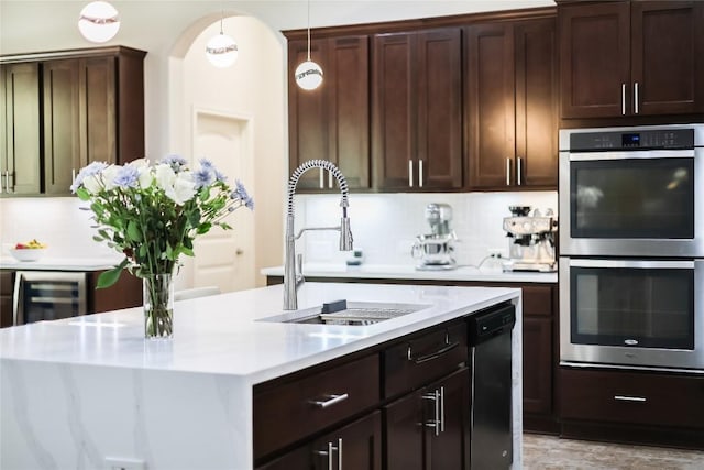 402 Dry Gulch Bnd, Cedar Park, TX 78613 - kitchen with appliances with stainless steel finishes, light countertops, wine cooler, dark brown cabinets, and decorative light fixtures
