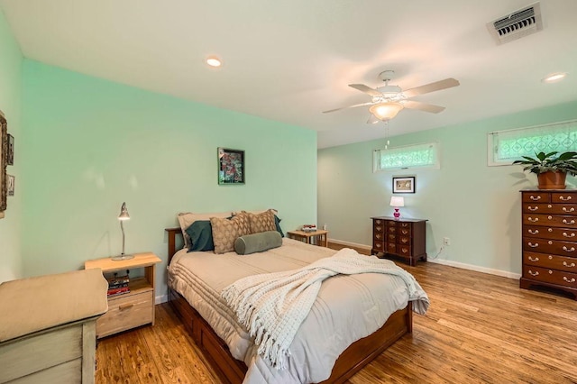 bedroom with wood finished floors, baseboards, ceiling fan, and recessed lighting
