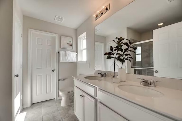 13417 Cerro Castellan Trce, Manor, TX 78653 - bathroom featuring double vanity, toilet, and a shower with shower door
