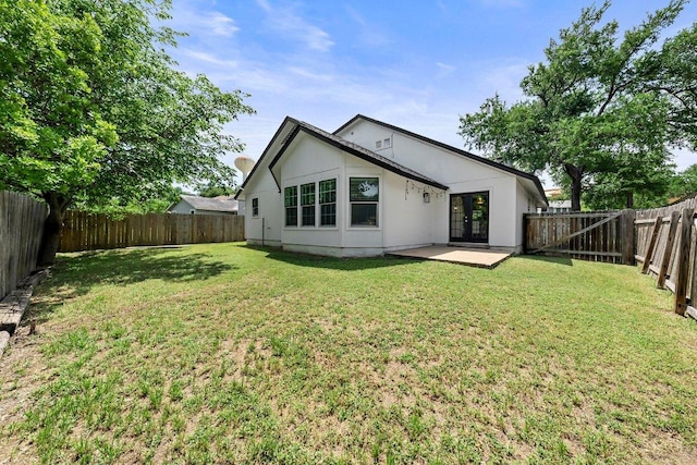 back of house with french doors and a patio