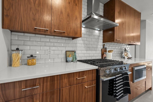 11701 Tanglebriar Trl, Austin, TX 78750 - kitchen featuring stainless steel range with gas stovetop, wall chimney range hood, light countertops, and backsplash