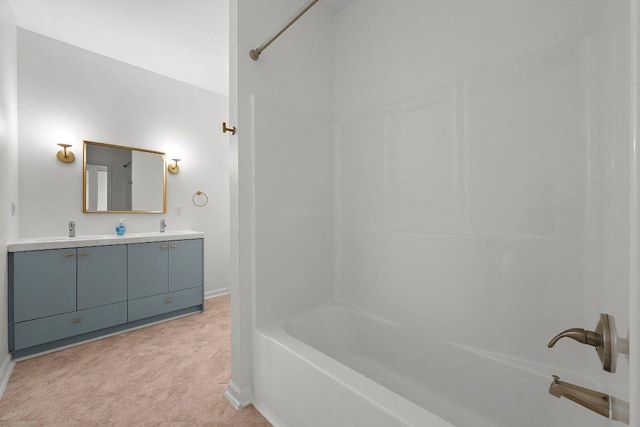 full bath with baseboards, double vanity, and tub / shower combination