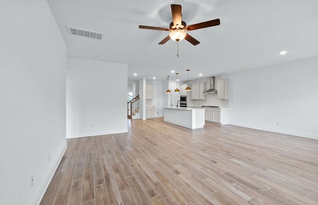 13404 Lapoynor St, Manor, TX 78653 - unfurnished living room featuring light wood finished floors, ceiling fan, and recessed lighting