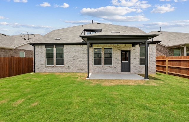 13404 Lapoynor St, Manor, TX 78653 - back of property featuring a patio area, a fenced backyard, brick siding, and a shingled roof