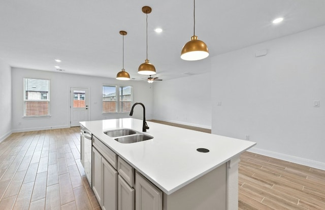 13404 Lapoynor St, Manor, TX 78653 - kitchen featuring light wood finished floors, light countertops, ceiling fan, dishwasher, and pendant lighting