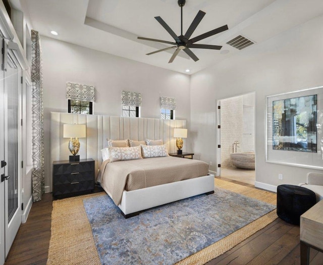 2510 Belaire E Ln, Granite Shoals, TX 78654 - bedroom with wood finished floors, recessed lighting, baseboards, a towering ceiling, and ensuite bathroom