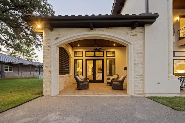2510 Belaire E Ln, Granite Shoals, TX 78654 - view of exterior entry with french doors, ceiling fan, and stucco siding
