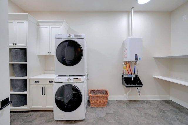2510 Belaire E Ln, Granite Shoals, TX 78654 - laundry room featuring stacked washing machine and dryer, cabinet space, and baseboards