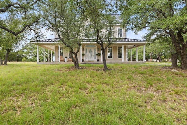 700 Longview Cir, Dripping Springs, TX 78620 - country-style home featuring a standing seam roof, metal roof, a ceiling fan, and a porch