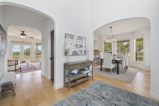 700 Longview Cir, Dripping Springs, TX 78620 - dining space with ceiling fan, light wood-type flooring, arched walkways, and baseboards