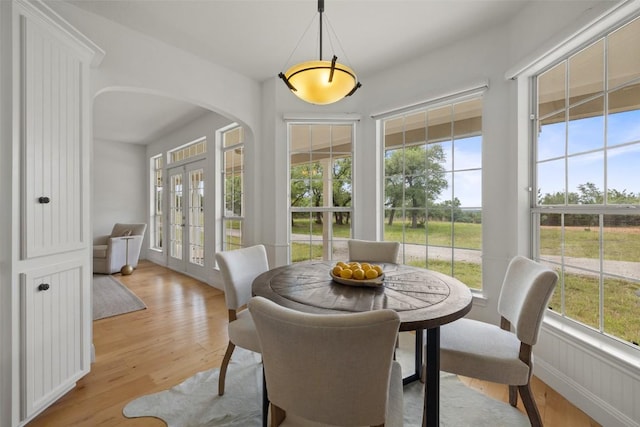 700 Longview Cir, Dripping Springs, TX 78620 - dining space featuring light wood-style flooring, french doors, and arched walkways