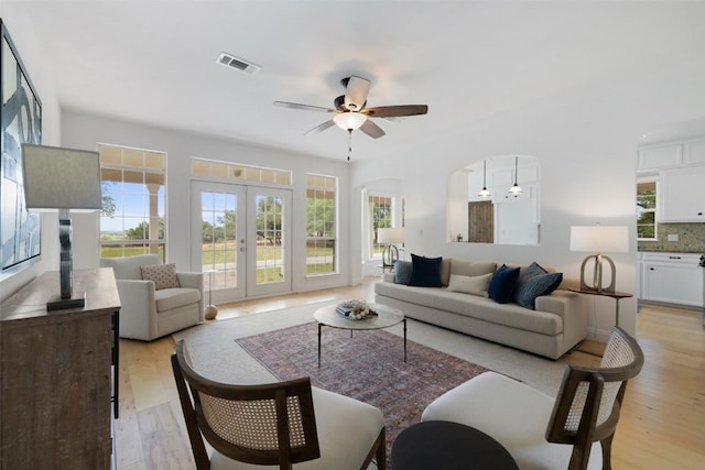 700 Longview Cir, Dripping Springs, TX 78620 - living room featuring a ceiling fan, light wood-style floors, and french doors