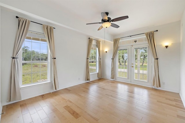 700 Longview Cir, Dripping Springs, TX 78620 - empty room featuring french doors, healthy amount of natural light, light wood-style floors, and ceiling fan