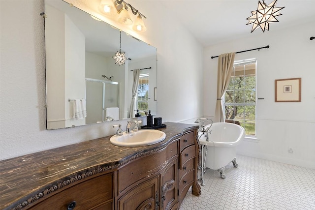 700 Longview Cir, Dripping Springs, TX 78620 - bathroom featuring a stall shower, healthy amount of natural light, vanity, and a freestanding tub