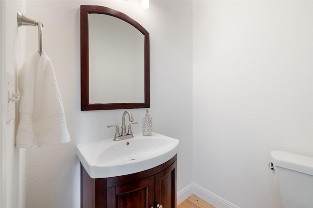 700 Longview Cir, Dripping Springs, TX 78620 - bathroom featuring vanity, baseboards, toilet, and wood finished floors