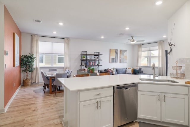 7812 City Top Blvd, Austin, TX 78724 - kitchen with dishwasher, light wood-style flooring, a peninsula, light countertops, and recessed lighting