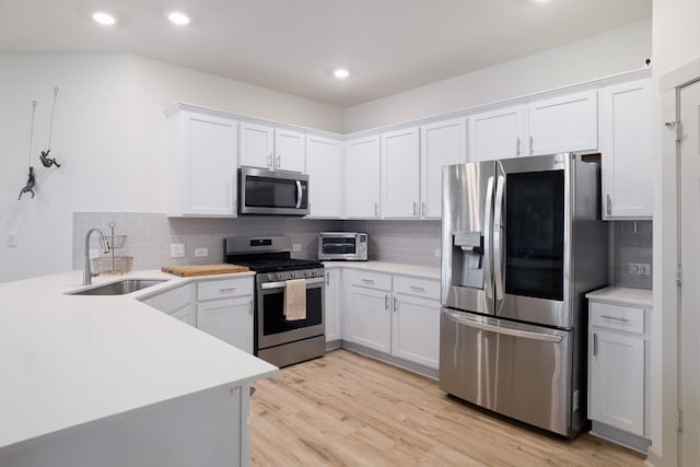7812 City Top Blvd, Austin, TX 78724 - kitchen featuring appliances with stainless steel finishes, decorative backsplash, white cabinets, light countertops, and recessed lighting