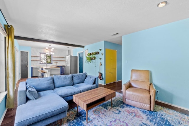 5105 Stone Gate Dr, Austin, TX 78721 - living room featuring a chandelier, baseboards, wood finished floors, a textured ceiling, and beam ceiling