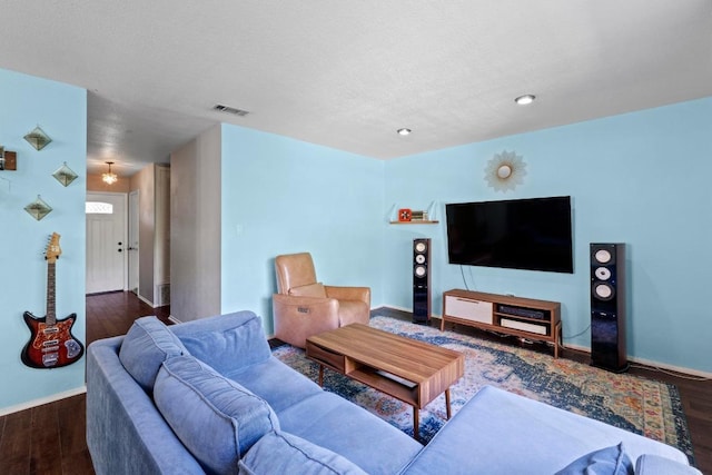 5105 Stone Gate Dr, Austin, TX 78721 - living area with wood finished floors, a textured ceiling, and recessed lighting