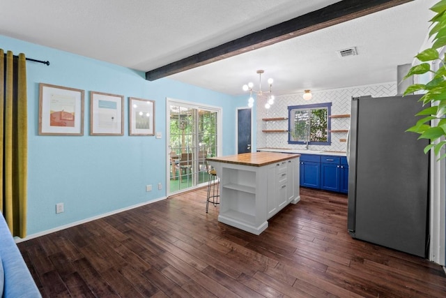 5105 Stone Gate Dr, Austin, TX 78721 - kitchen featuring open shelves, freestanding refrigerator, butcher block counters, white cabinetry, and beam ceiling