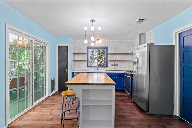 5105 Stone Gate Dr, Austin, TX 78721 - kitchen featuring open shelves, stainless steel appliances, butcher block countertops, blue cabinetry, and dark wood-style floors