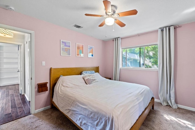5105 Stone Gate Dr, Austin, TX 78721 - carpeted bedroom with baseboards and a ceiling fan