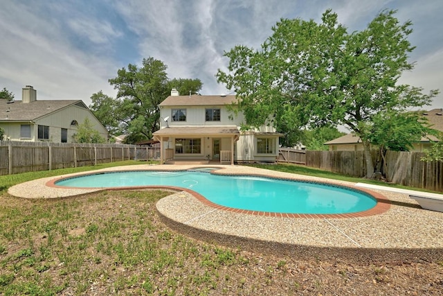 view of pool featuring a fenced backyard, a diving board, and a patio
