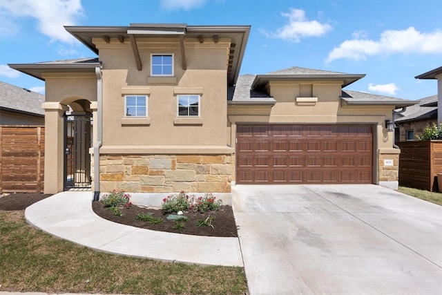 905 Indian Hawthorne Dr Unit G, Georgetown, TX 78628 - view of front facade featuring stone siding, an attached garage, stucco siding, and driveway