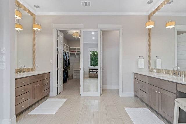 1107 Challenger, Lakeway, TX 78734 - bathroom featuring two vanities, crown molding, and a spacious closet
