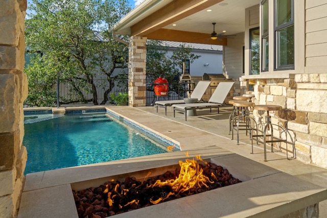 1107 Challenger, Lakeway, TX 78734 - view of pool with an outdoor fire pit, a patio area, a ceiling fan, and a pool with connected hot tub