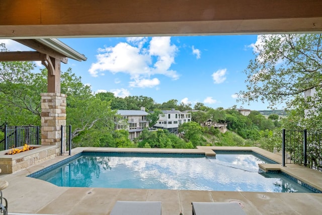 1107 Challenger, Lakeway, TX 78734 - view of swimming pool with a pool with connected hot tub, view of wooded area, and a patio