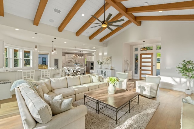 1107 Challenger, Lakeway, TX 78734 - living room featuring light wood-style flooring, ceiling fan, recessed lighting, beamed ceiling, and a chandelier