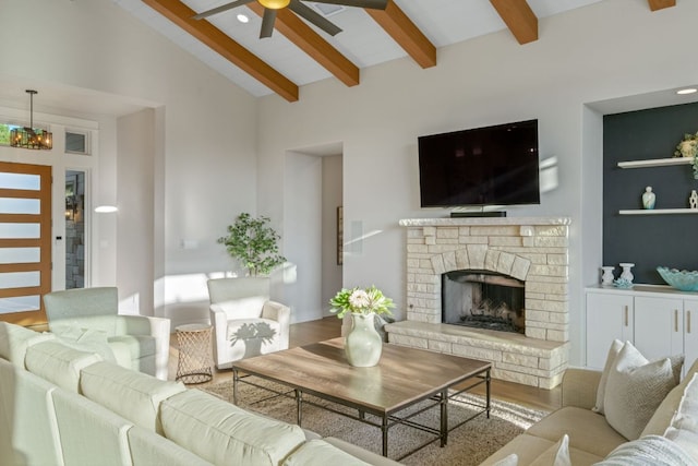 1107 Challenger, Lakeway, TX 78734 - living area with beam ceiling, a ceiling fan, a fireplace with raised hearth, wood finished floors, and high vaulted ceiling