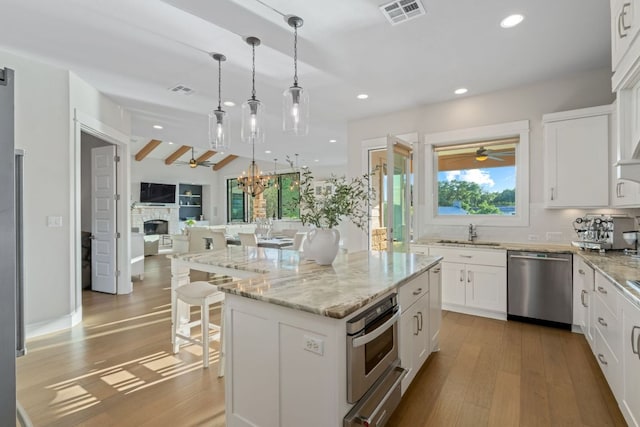 1107 Challenger, Lakeway, TX 78734 - kitchen featuring stainless steel appliances, a warming drawer, tasteful backsplash, open floor plan, and recessed lighting