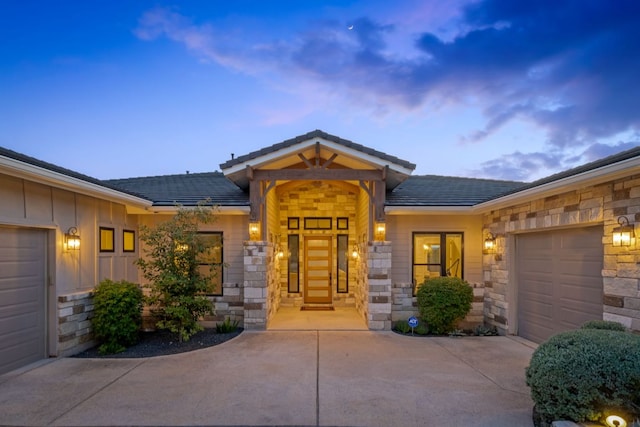 1107 Challenger, Lakeway, TX 78734 - view of front of property featuring a garage, concrete driveway, stone siding, and board and batten siding
