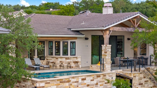 1107 Challenger, Lakeway, TX 78734 - back of house with a tile roof, a chimney, stone siding, outdoor dining area, and a patio area