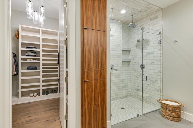 2010 Goodrich Ave Unit 5A, Austin, TX 78704 - bathroom featuring a stall shower, a spacious closet, and wood finished floors