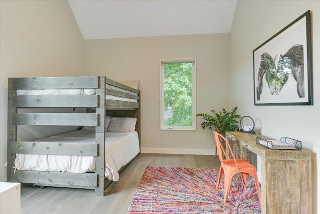 2010 Goodrich Ave Unit 5A, Austin, TX 78704 - bedroom with vaulted ceiling, wood finished floors, a desk, and baseboards
