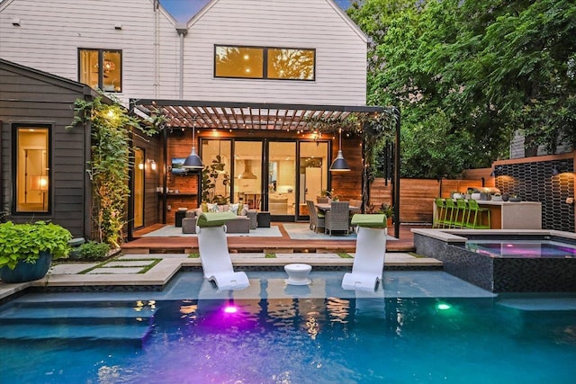 2010 Goodrich Ave Unit 5A, Austin, TX 78704 - back of property featuring a wooden deck, an outdoor hangout area, and a pool with connected hot tub