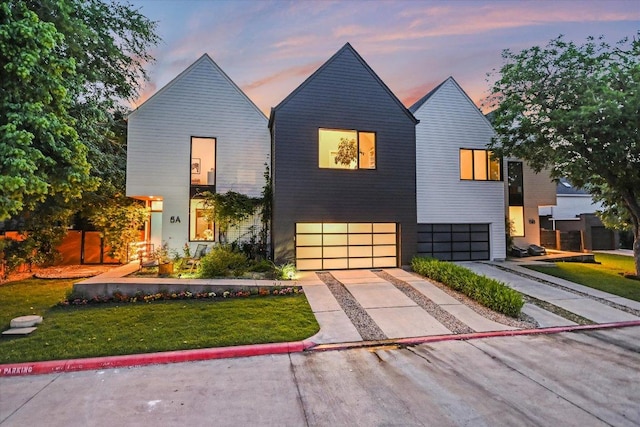 2010 Goodrich Ave Unit 5A, Austin, TX 78704 - view of front of house with an attached garage, concrete driveway, and a yard