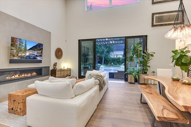 2010 Goodrich Ave Unit 5A, Austin, TX 78704 - living area with a towering ceiling, wood finished floors, and a glass covered fireplace