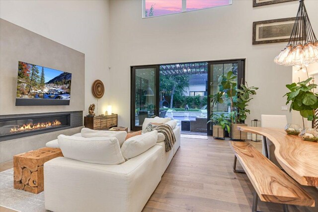 2010 Goodrich Ave Unit 5A, Austin, TX 78704 - living area with a high ceiling, a glass covered fireplace, wood finished floors, and healthy amount of natural light