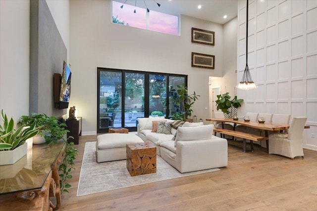 2010 Goodrich Ave Unit 5A, Austin, TX 78704 - living area featuring a towering ceiling, wood finished floors, and recessed lighting