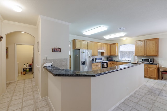 5219 Moon Shadow Dr, Austin, TX 78735 - kitchen featuring stainless steel appliances, ornamental molding, arched walkways, under cabinet range hood, and decorative backsplash