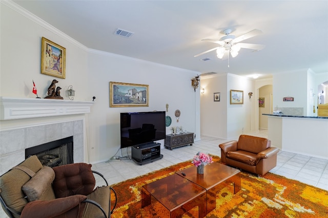 5219 Moon Shadow Dr, Austin, TX 78735 - living room with light tile patterned flooring, arched walkways, ceiling fan, ornamental molding, and a tile fireplace
